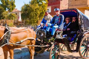 Friendly Egyptian cruise staff welcoming travelers on board