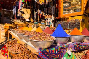 Bustling main street of Aswan Old Market with colorful shops