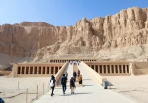 Tourists dressed modestly exploring ancient Egyptian temple